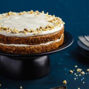 Two layer carrot cake on cake stand.