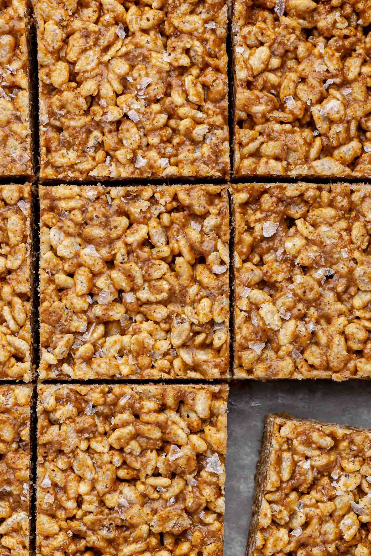 Close up view of salted caramel vegan rice crispy treats after being cut into nine pieces.
