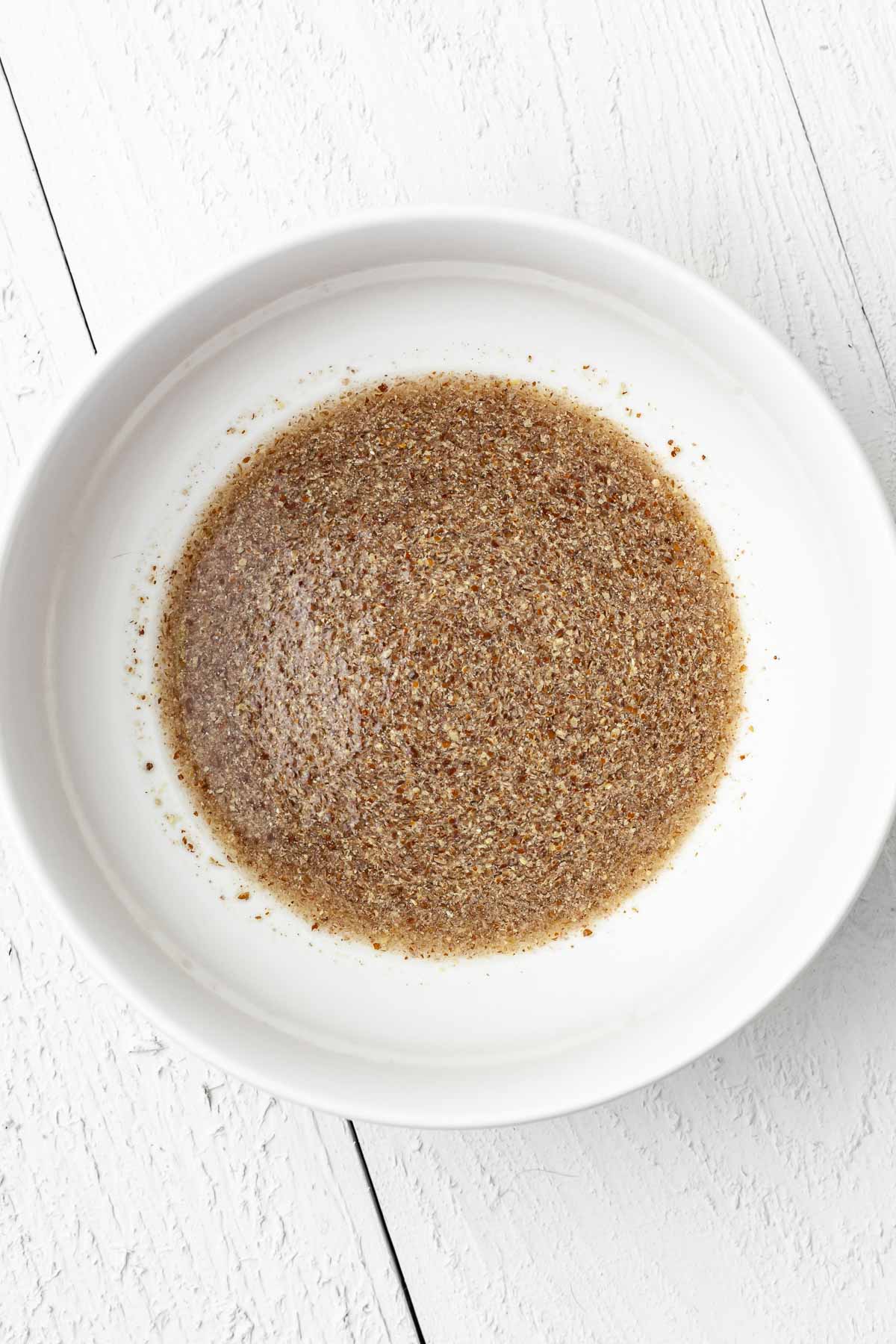 Flax and water "flax egg" mixture in a small white bowl.