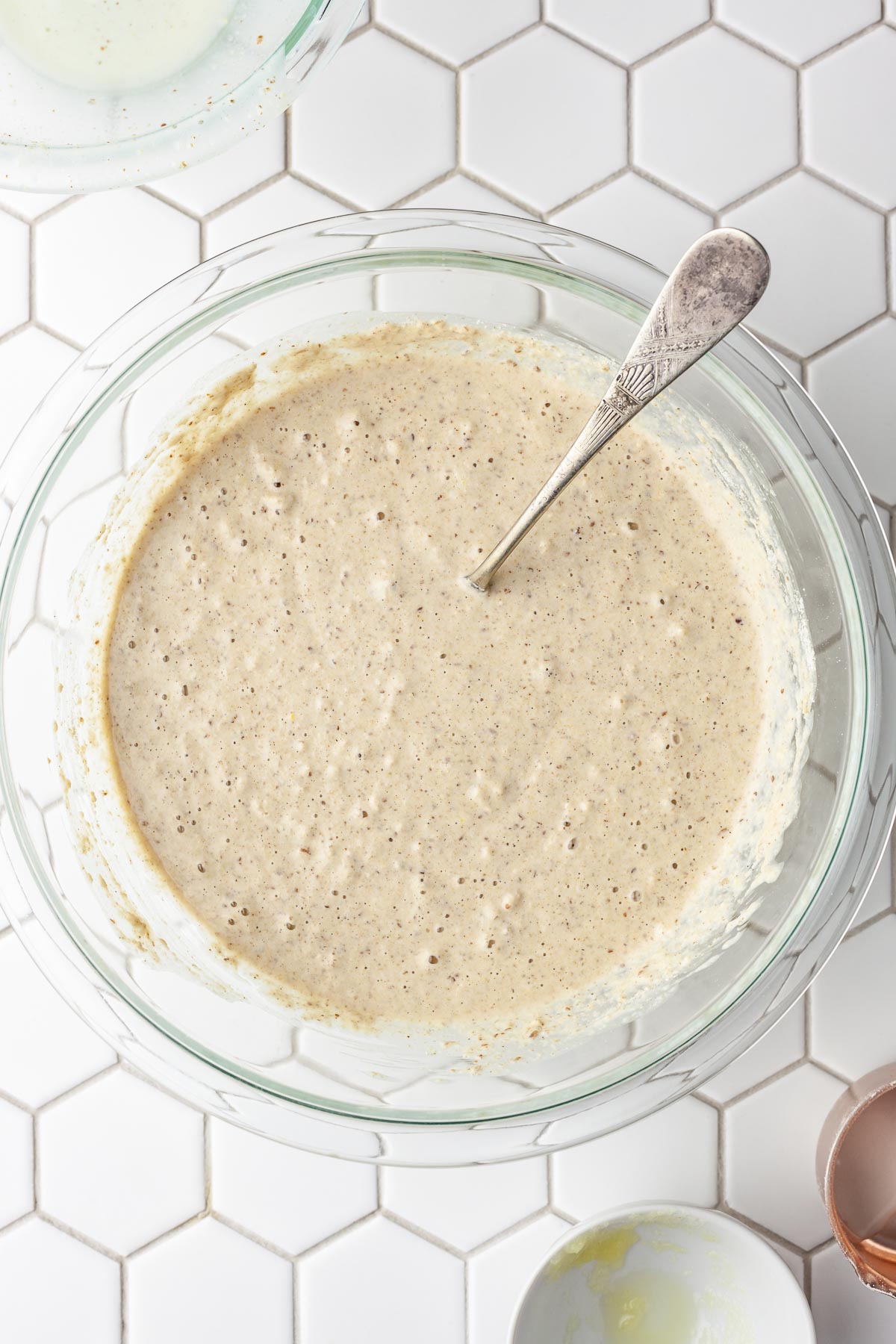 Overhead view of a bowl of oat flour pancake batter.
