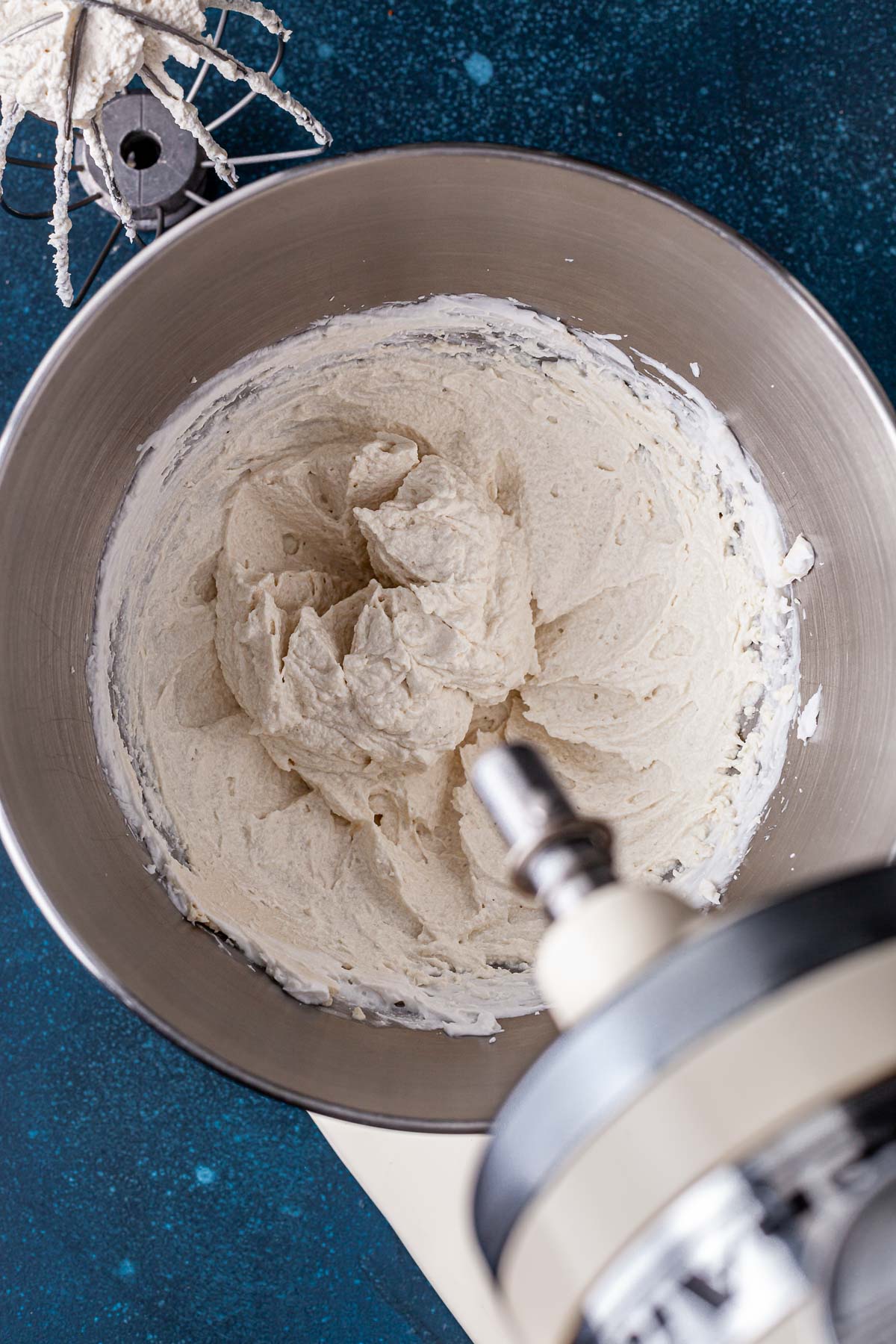 Coconut cream and vegan cream cheese whipped together in the bowl of a stand mixer.